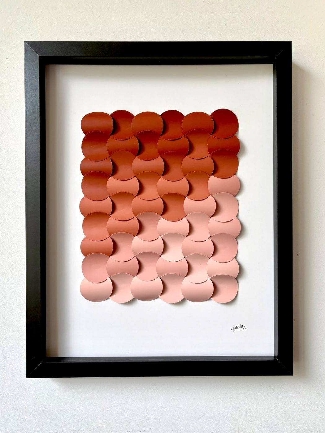 Framed scalloped paper piece in an ombre from red to blush